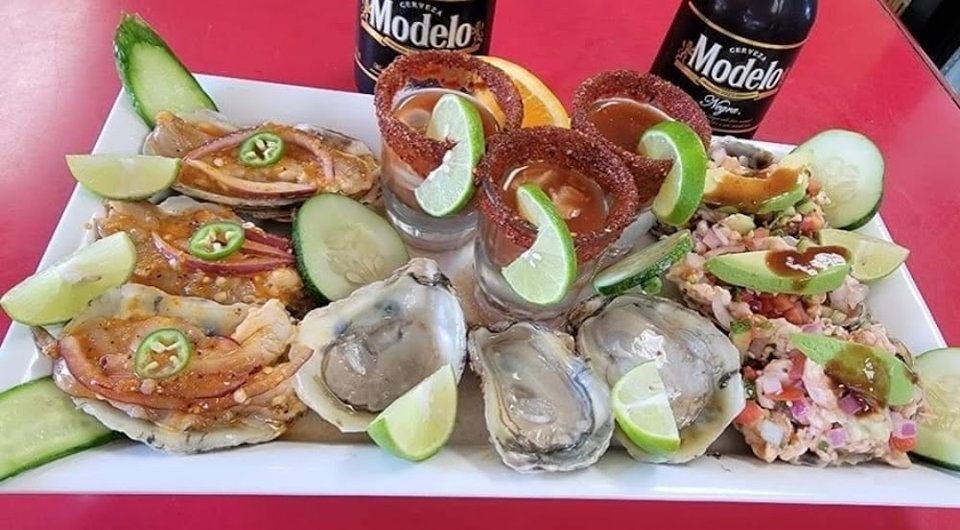 Printed menu with tacos and seafood.