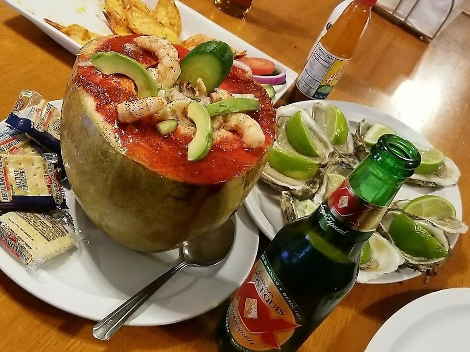 Printed menu with tacos and seafood.